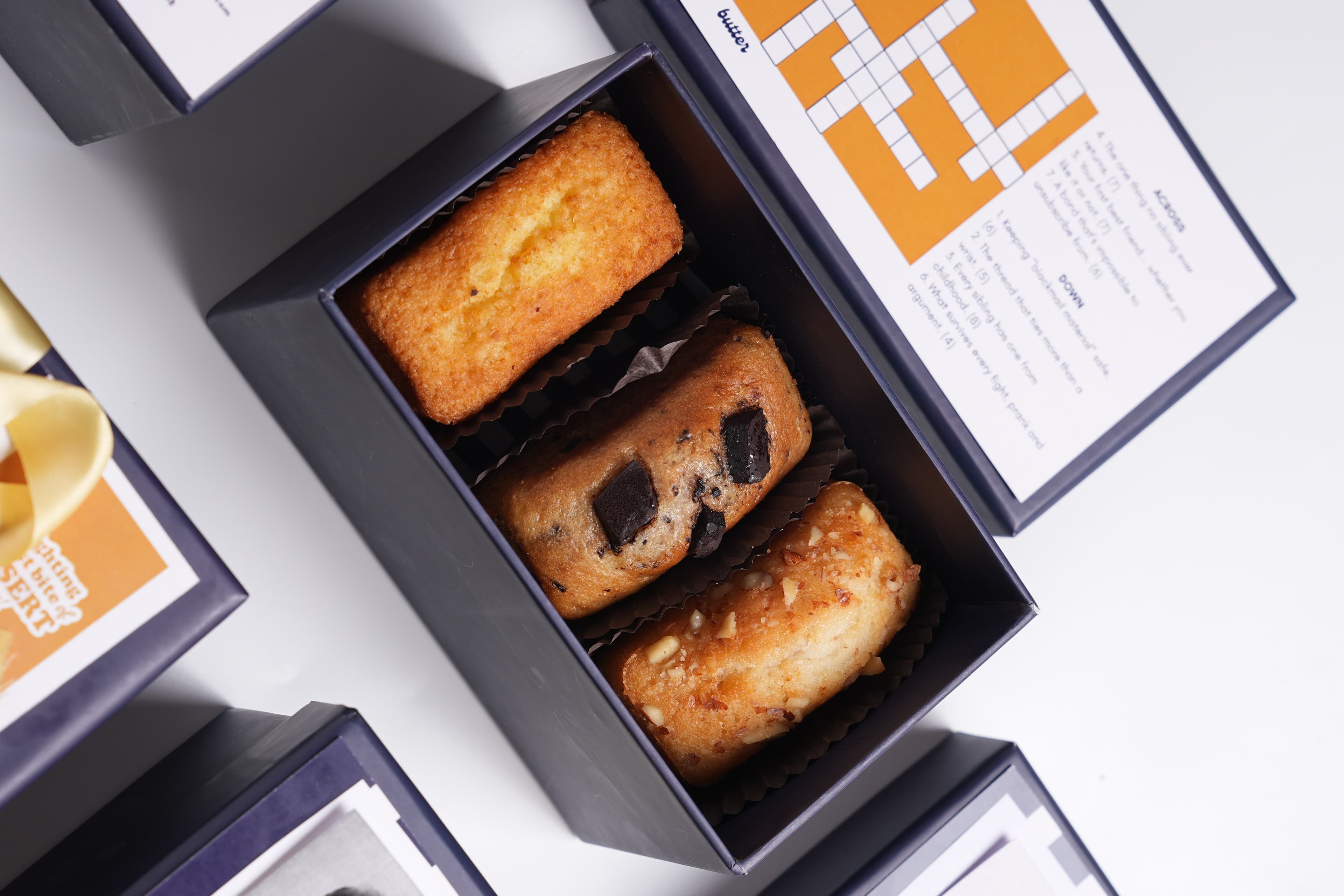Open Memory Edit box with mini loaf cakes and sibling crossword — order in Jaipur